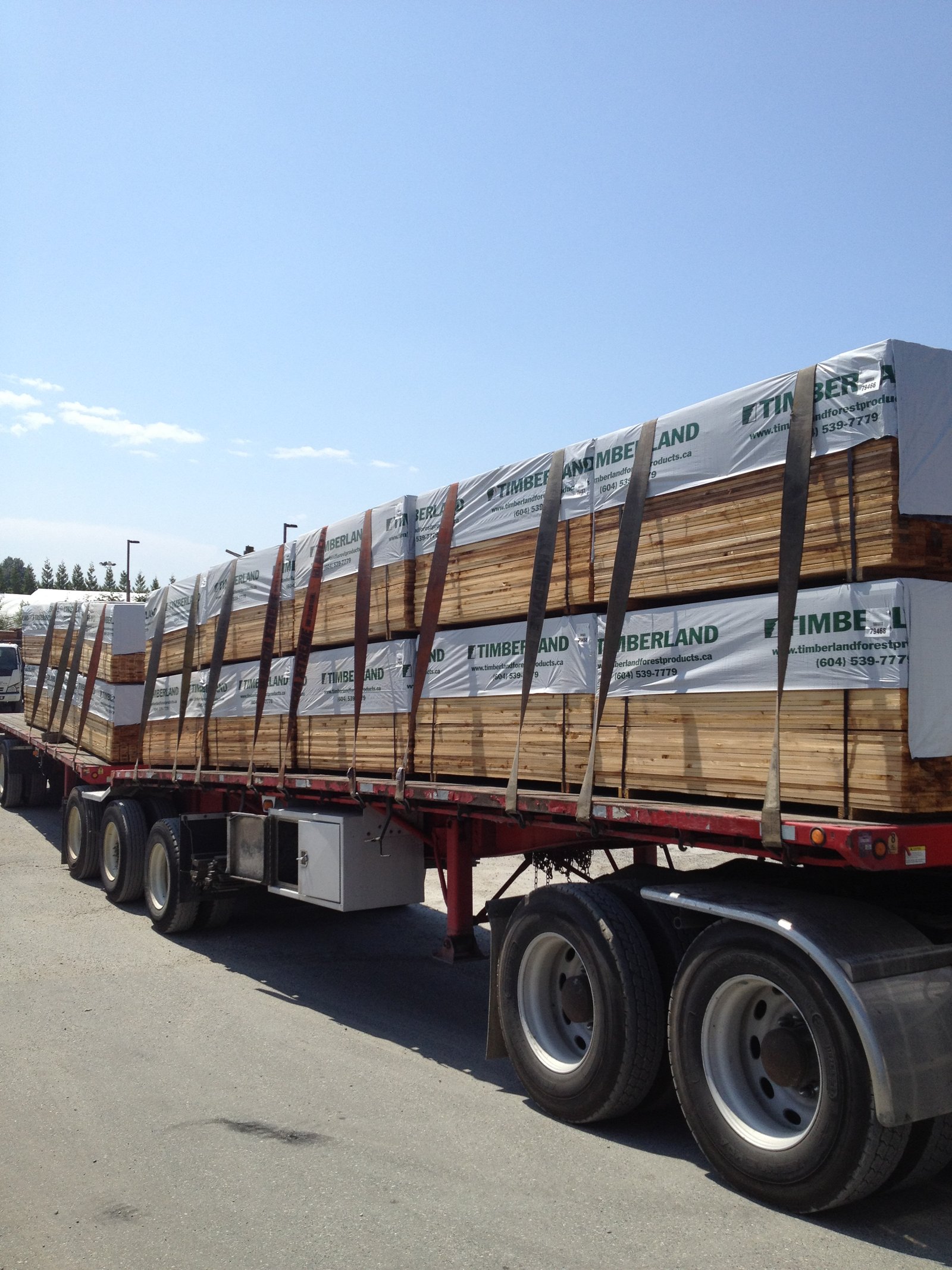 Flatbed loaded with branded Timberland cedar lumber packs