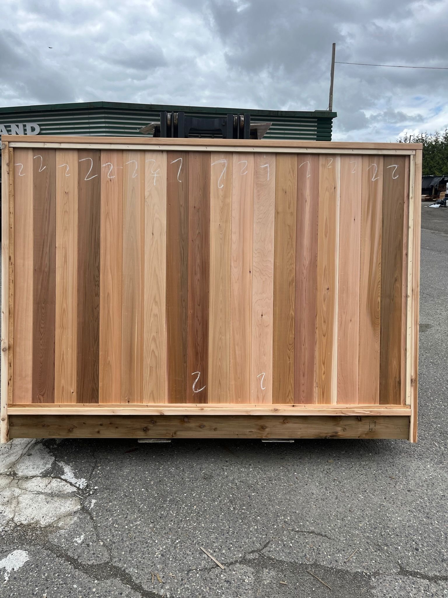 Numbered cedar fence panels staged for shipping