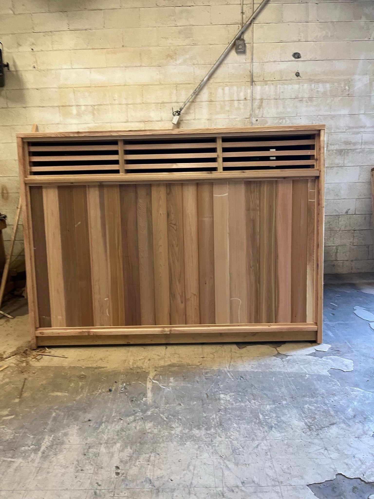 Clear cedar fence panel with slatted top vent detail